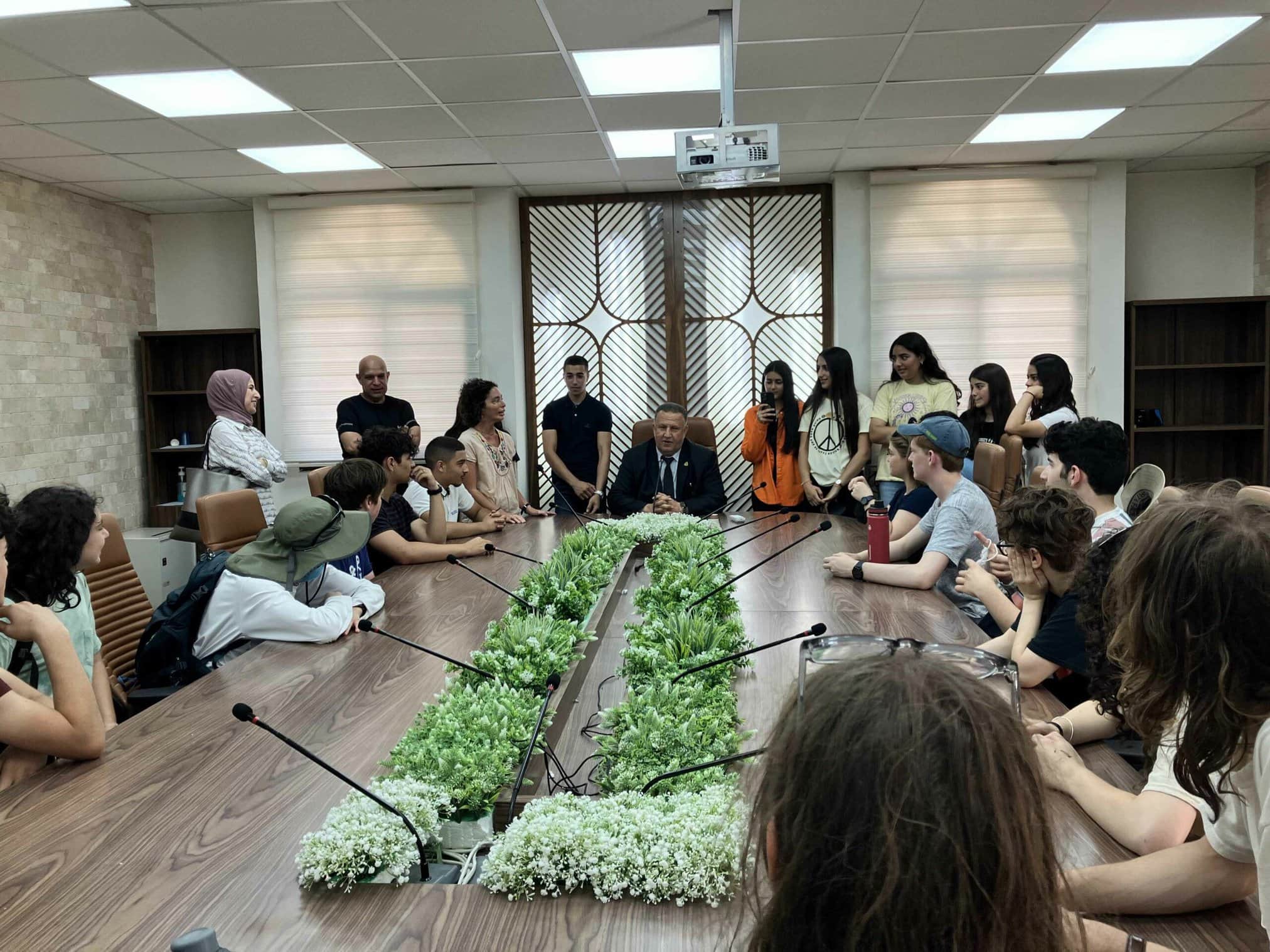 Group of students engaging with a speaker in a conference room.