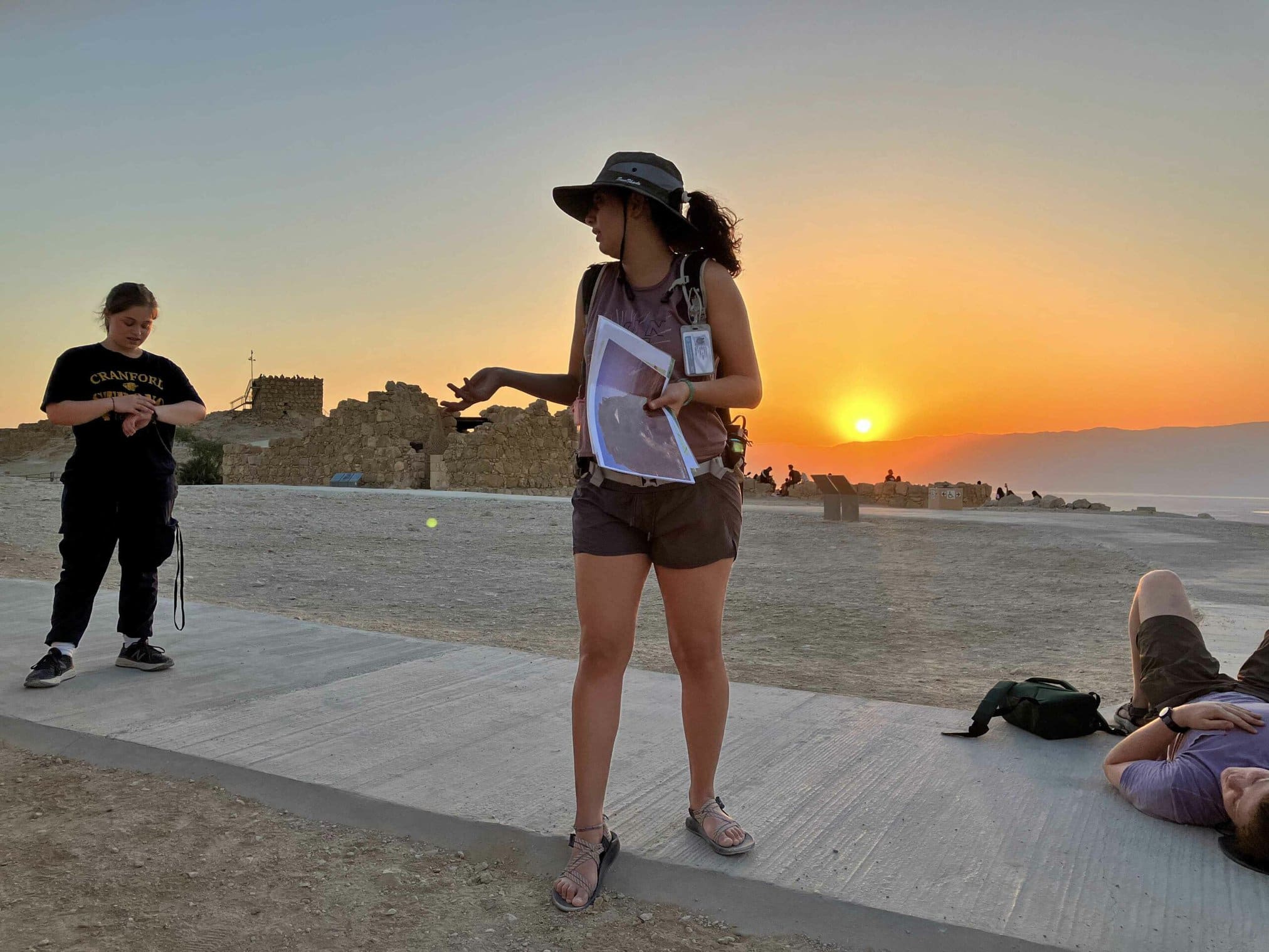 people outside at sunset