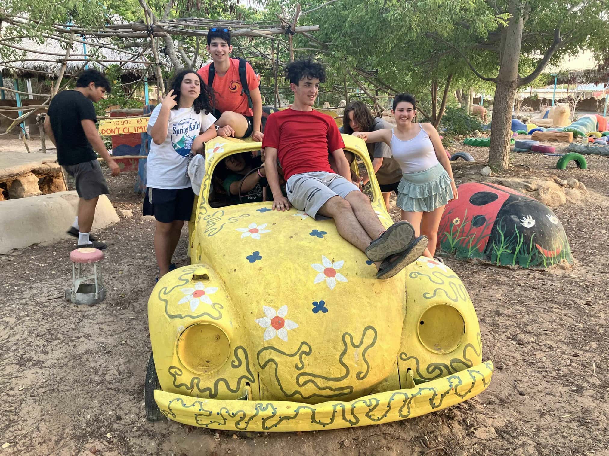 youth posing on a decorative car