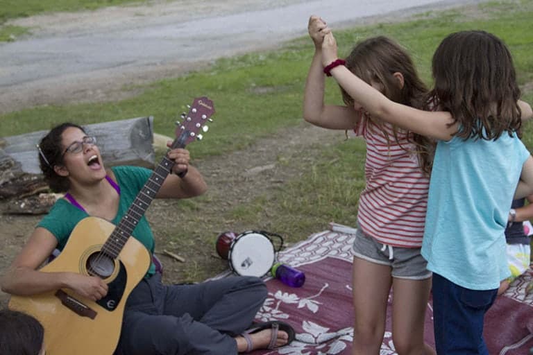 Children enjoying outdoor music and dance activities at Eden Village Camp, a family-friendly summer camp focused on community, nature, and sustainability.